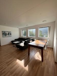 a living room with a couch and a table at Cozy apartment in Seydisfjordur in Seyðisfjörður