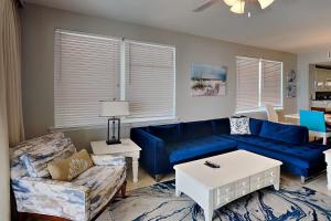 a living room with a blue couch and a table at Summerwinds #204 in Navarre +45 photos