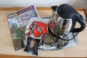 a table with a tea pot and other items on it at Greenside Guesthouse in York