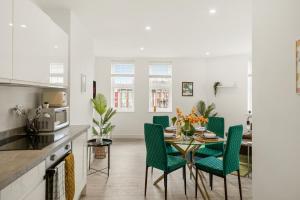 a kitchen and dining room with a table and chairs at Livestay-Modern One and Two Bed Apartments in Burnt Oak London in Edgware