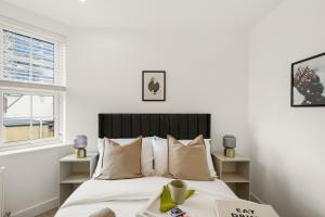una camera con letto e finestra di Livestay-Modern One and Two Bed Apartments in Burnt Oak London a Edgware