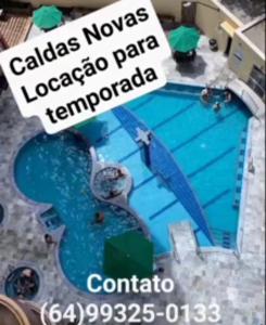 a picture of a swimming pool with a sign next to it at Splendor Thermas in Caldas Novas