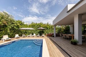 un cortile con piscina e una casa di Villa Diagonal a Can Picafort