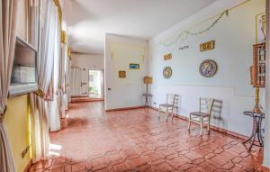 a living room with two chairs and a tile floor at Beautiful Apartment In Staletti With Wifi And 2 Bedrooms in Stalettì