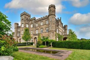 an old castle with a pond in front of it at Finest Retreats - Apley Hall in Bridgnorth