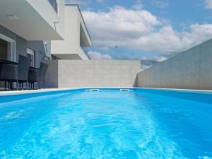 a swimming pool in front of a building at Villa Kana in Umag