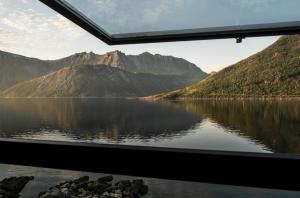 a view of a lake from a train window at Polar Panorama Lodge in Fjordgård