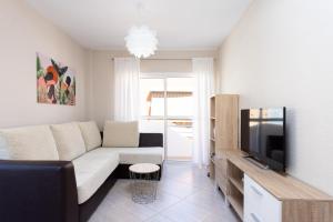 a living room with a couch and a tv at Home2Book Attic Terrace Apt Charming Ocean View in Candelaria