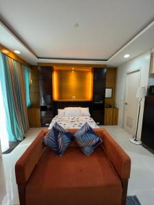 a large bedroom with a large bed with two pillows at One Palmtree Villas Airport Condo in Manila