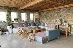 a living room with a couch and a table at Villa Joy in Fanari