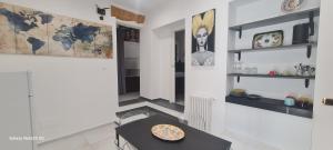 a room with a table with a pizza on it at Arte in piazza Agrigento centro in Agrigento