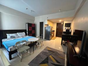 a bedroom with a bed and a table and chairs at One Palmtree Villas Airport Condo in Manila
