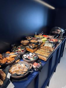 a blue table with many different types of food at The Newel Acropolis in Athens