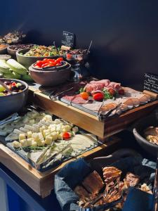 a buffet filled with lots of different types of food at The Newel Acropolis in Athens
