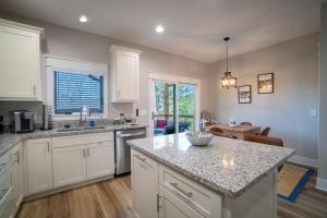 a kitchen with white cabinets and a counter top at Walk to Helen Downtown-Gated Golf Resort in Helen