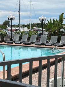 a swimming pool with lounge chairs next to a resort at Marina Vibes - Sarasota in Sarasota