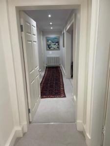 einen leeren Flur mit einem Teppich auf dem Boden und einem Hallwayngthngthngthngthngth in der Unterkunft Merchiston Residence in Edinburgh