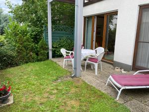 a patio with a table and chairs on a house at Appartements Gloeser in Badenweiler