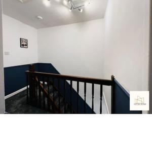 a room with a staircase with blue and white walls at Monthly Offers, 7 Guests, Business, WIFI in Wyken