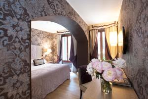 Łóżko lub łóżka w pokoju w obiekcie Splendid Venice - Starhotels Collezione
