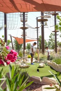 two people playing golf on a miniature golf course at City of Dreams Mediterranean - Integrated Resort, Casino & Entertainment in Limassol