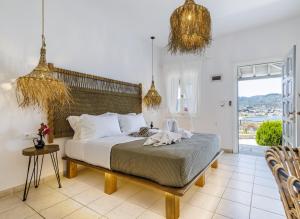 a bedroom with a large bed and a large window at Ourania Studios & Apartments in Skopelos Town +80 photos