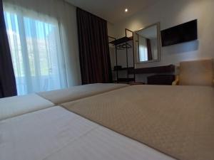 Postel nebo postele na pokoji v ubytování Hotel Relax Dhermi