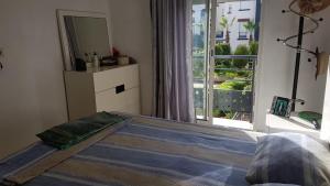 a bedroom with a bed with a mirror and a window at Magic House Mansouria in Mansouria