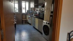a kitchen with a washer and dryer on a tile floor at Magic House Mansouria in Mansouria