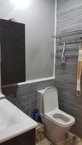 a bathroom with a white toilet and a sink at Magic House Mansouria in Mansouria