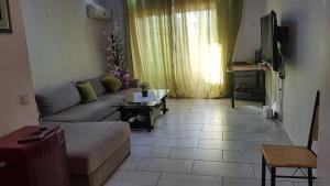 a living room with a couch and a table at Magic House Mansouria in Mansouria +4 photos