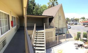 a building with stairs in front of a building at Discovery Inn in Modesto