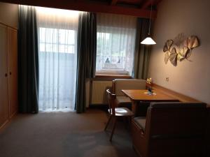 a dining room with a table and a window at Residence Alpenrose in Sesto