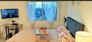 a living room with a couch and a window at Departamento Centrico Tandil in Tandil