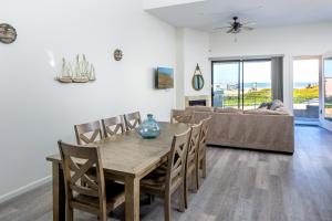 a dining room with a table and a couch at Barefoot Wishes in Oceano