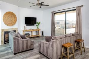 a living room with two couches and a fireplace at Barefoot Wishes in Oceano