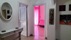 a bathroom with a pink chair and a mirror at Casa Vacanza Casale in Brindisi +4 photos