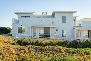 a house on a hill with a yard at Barefoot Wishes in Oceano