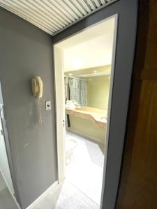 a bathroom with a mirror and a phone on the wall at Apart hotel Ciudad de Bs As in Buenos Aires