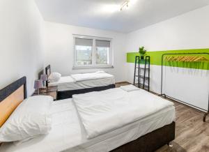 a room with three beds and a window at Modern 3-BR Apmt. Sleeps 6+ (Martin-der-Meisterliche) in Essen