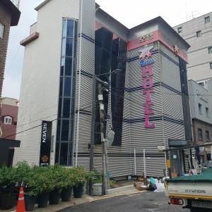 a building with a sign on the side of it at Seven Hostel in Seoul