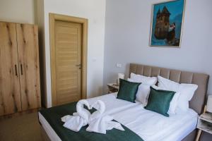 Un pat sau paturi într-o cameră la AVIOR Garni Hotel
