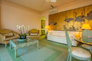 a living room with a bed and a table at Grand Hotel Villa Castagnola in Lugano