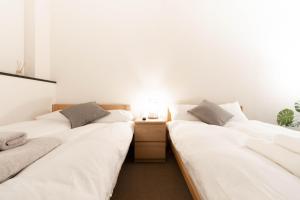 Postel nebo postele na pokoji v ubytování 鶴橋妙宅