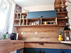 a kitchen with a counter with wooden shelves at Rare view in Plovdiv