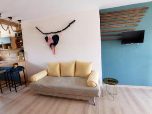 a living room with a couch against a wall at Rare view in Plovdiv