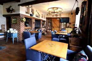 a dining room with blue chairs and a table at Domaine "Le Ry d'Ave" in Rochefort