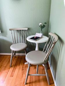 two chairs and a table with a book on a table at Petrines Gjestgiveri in Norddal