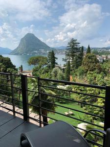 a balcony with a view of a lake and a mountain at Grand Hotel Villa Castagnola in Lugano