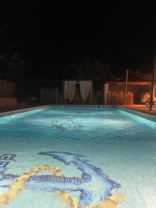 a swimming pool at night with the number in the water at Les jardins de Manotte in La Motte